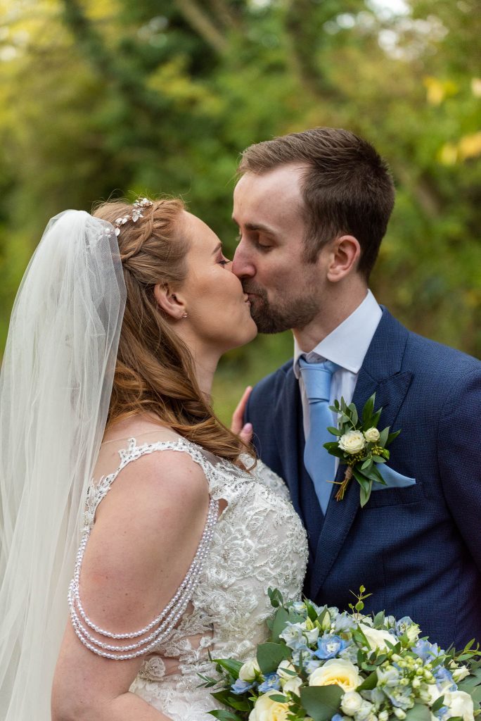 Bride and groom sharing a tender kiss at Lea Marston Hotel wedding Sutton Coldfield wedding
