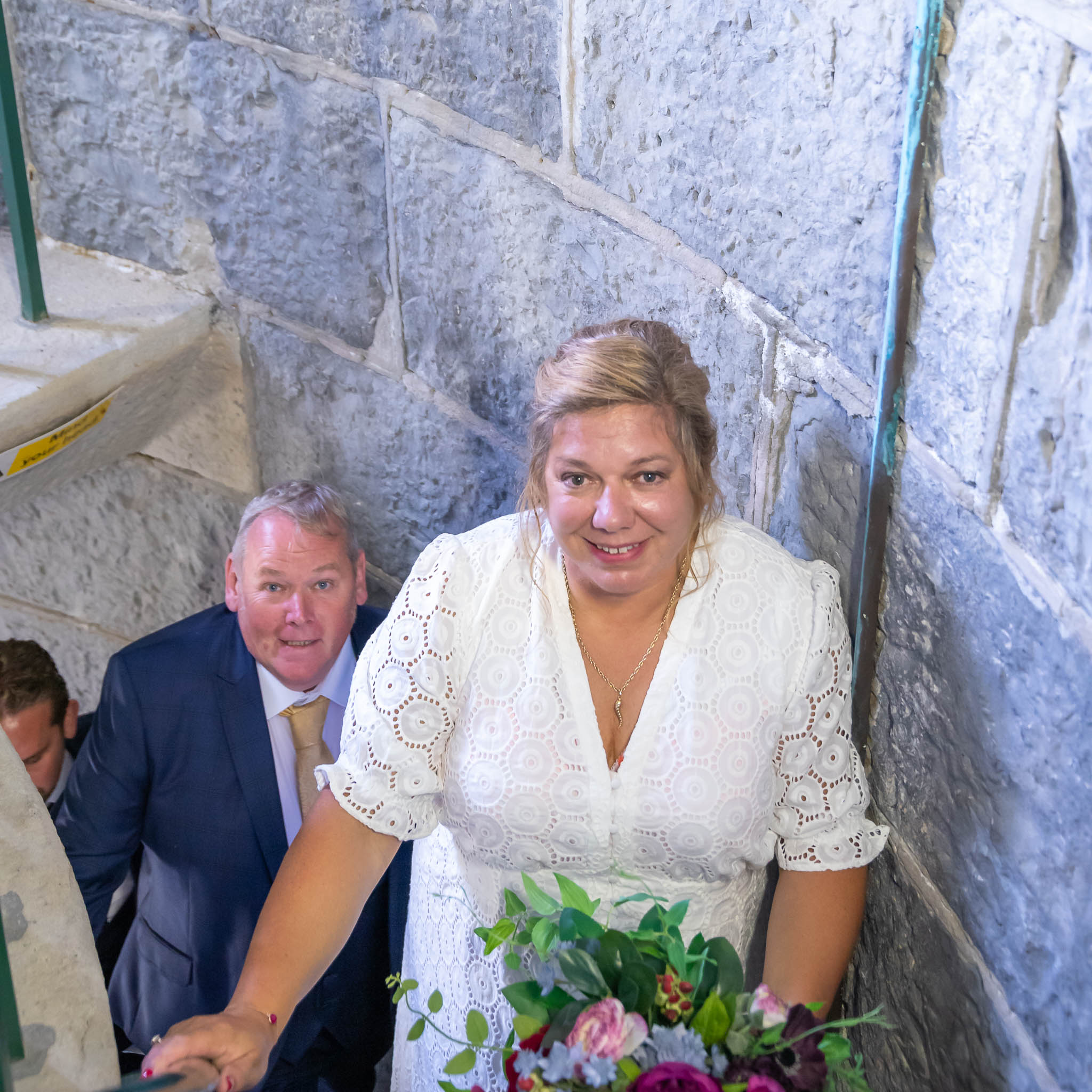 The bride and groom climb the stairs of Nash Point lighthouse after their wedding captured by Hannah Clegg Photography