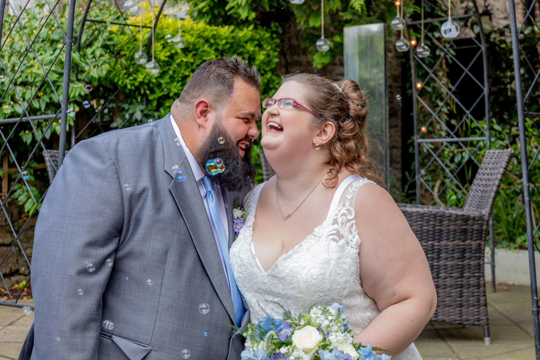 The bride and Groom share a laugh after their wedding in Cowbridge captured by Hannah Clegg Photography