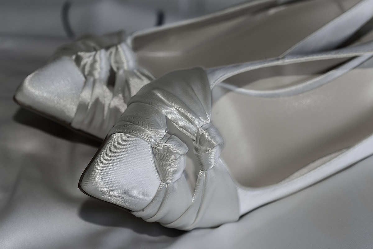 A closeup shot of a pair of sparking silver shoes for the bride to wear.