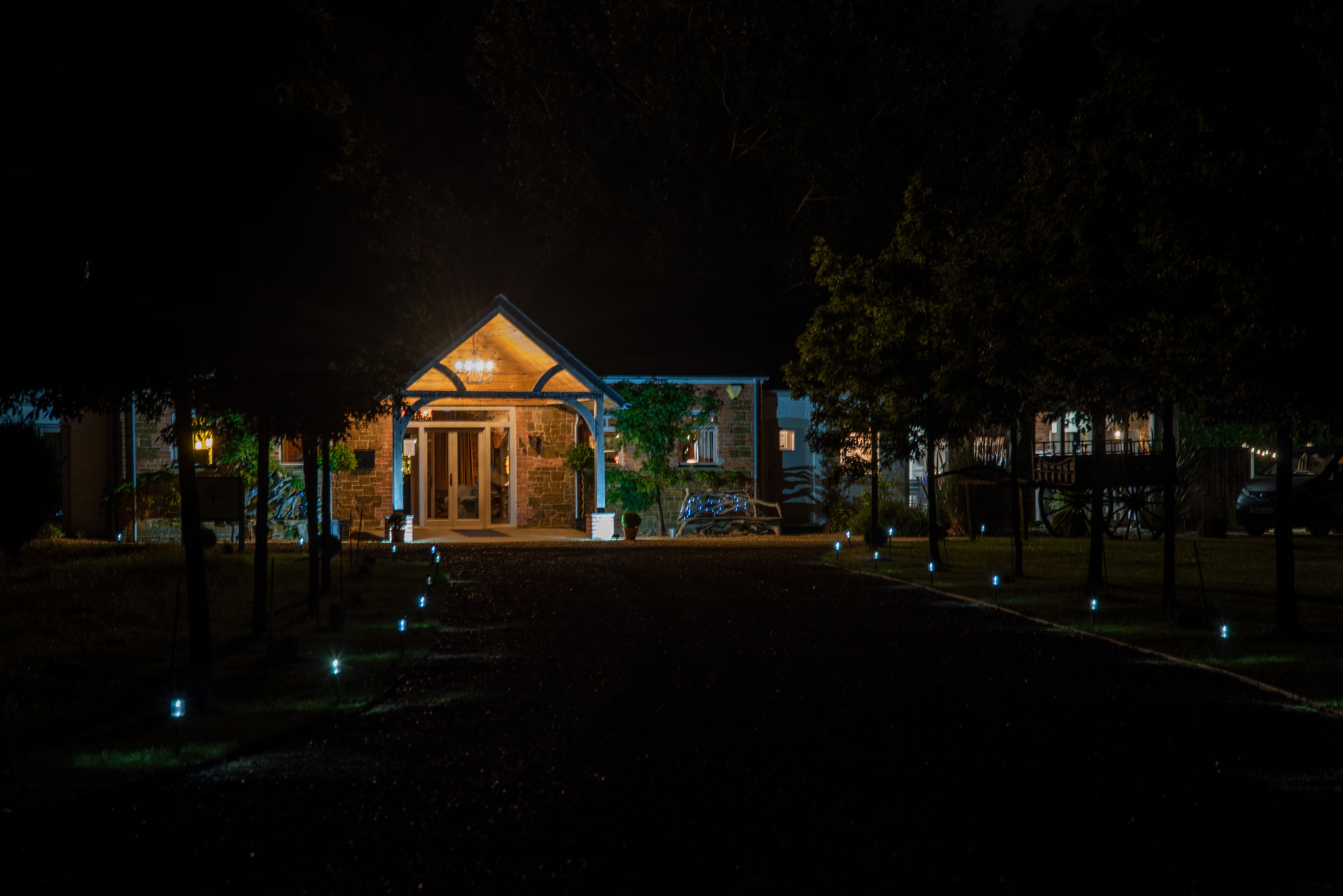An illuminated evening view of Oak Tree Barns wedding venue in Narborough lit up at night.